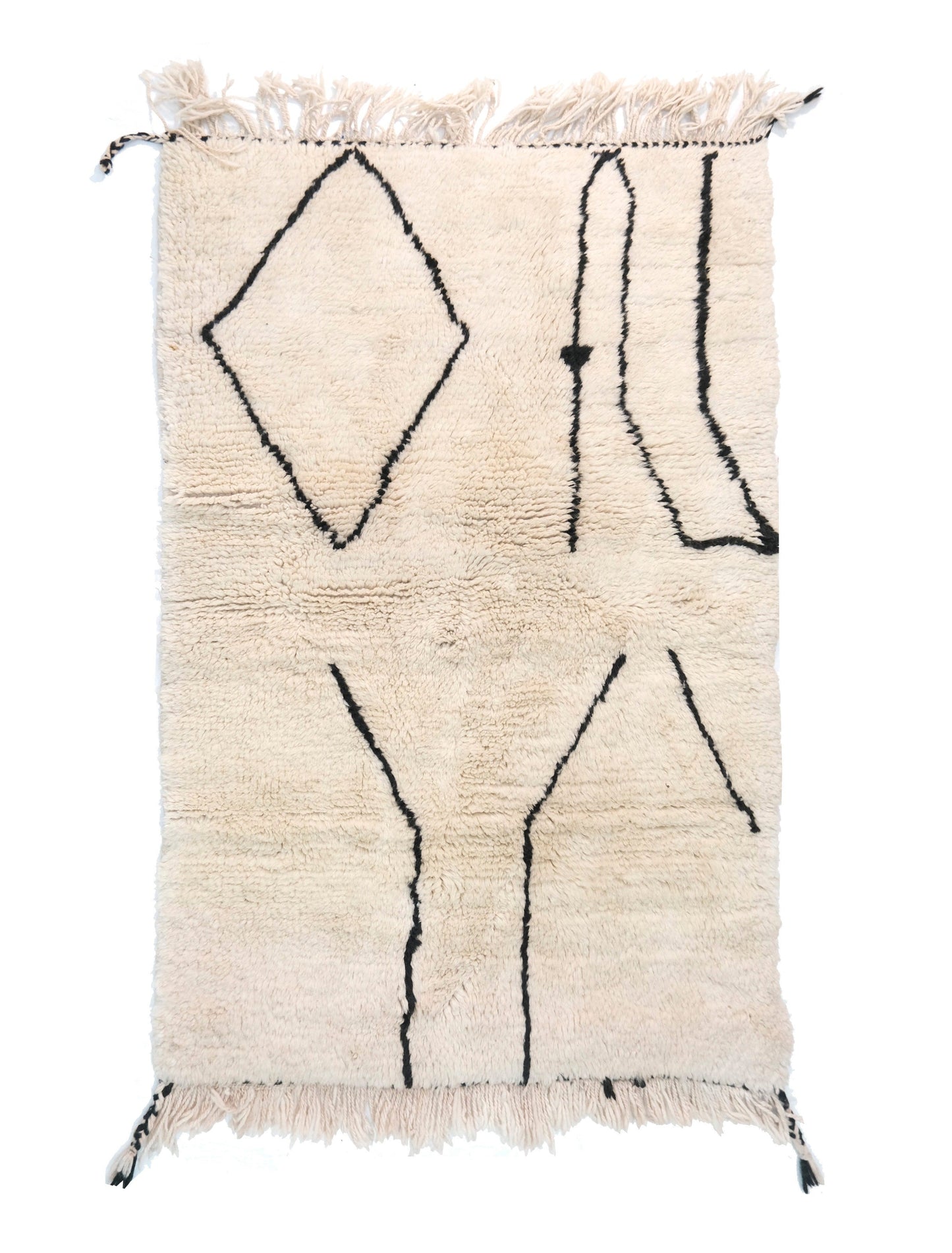 A cream-colored handwoven Moroccan shag rug featuring minimalist black line art, including a large diamond shape, vertical wavy lines, and Y-shaped branches, with cream fringe and black corner accents on the edges.

