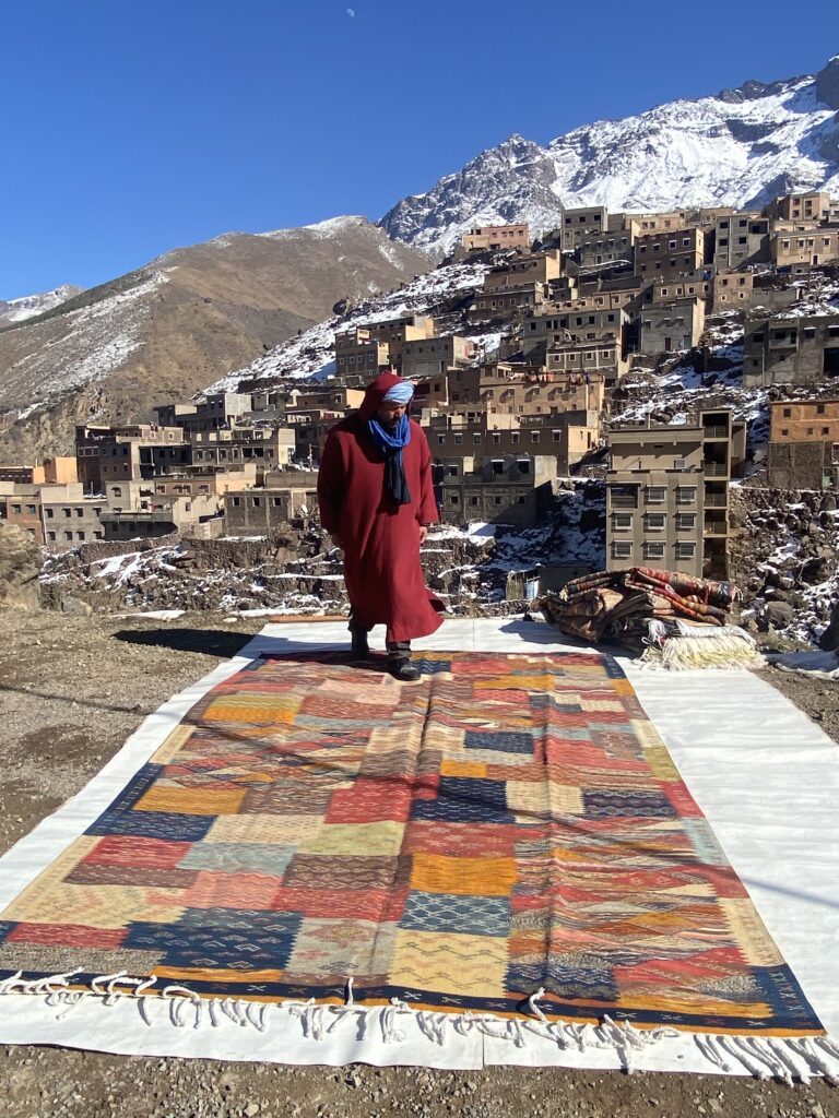 Handwoven Moroccan rug featuring geometric tribal patterns and earthy tones