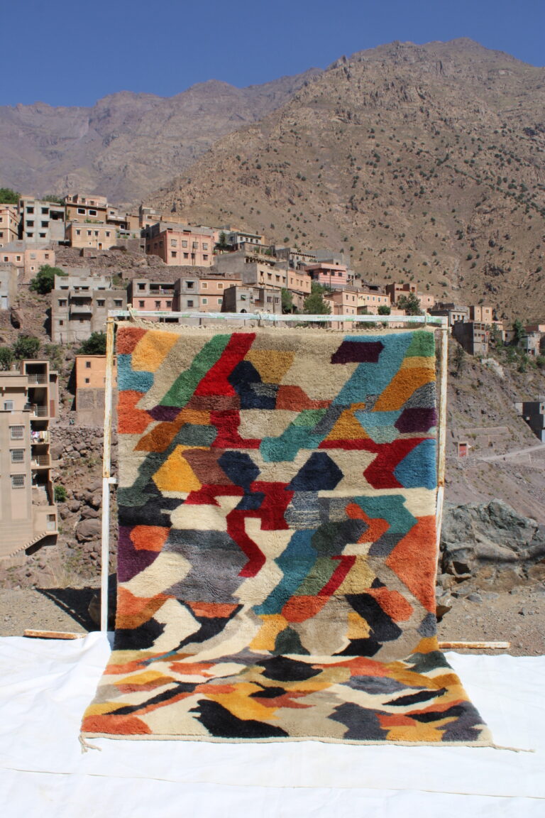 Colorful Moroccan area rug with traditional Berber motifs and fringe edges